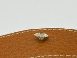 the inside of a brown leather purse with a small diamond on it
