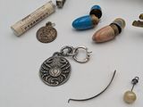 a white table topped with assorted jewelry and a ruler