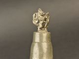 statue of an elephant on top of a bell on a table
