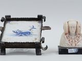 two figurines of a woman and a dog on a table