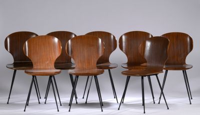 four wooden chairs with black legs and a white background