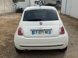 a small white car parked in front of a building