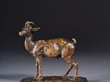 an image of a bronze statue of a goat on a base