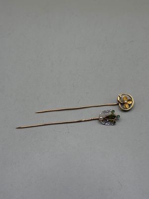 pair of gold and silver hair pins with green stones