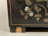 a small black box with a gold design on it