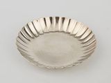 an antique silver plate with a fluted edge