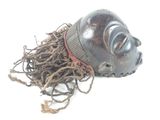a wooden mask with a rope around it on a white surface