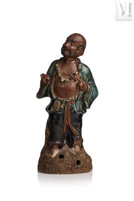 an image of a statue of a man holding a drum