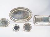 several pieces of silver are arranged on a white surface