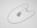 a close up of a gold chain with a tag on it