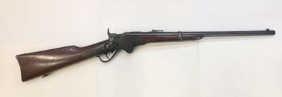 a rifle that is on display on a wall