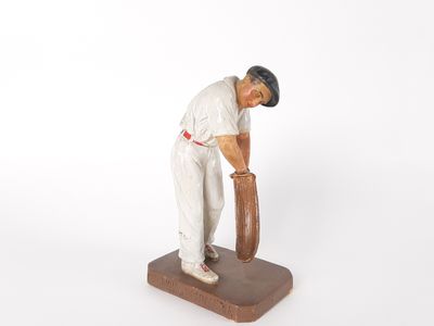 figurine of a baseball player with a bat on a base
