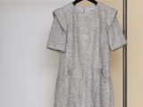 the dress is hanging on a clothes rack in a room