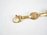 a close up of a gold chain with a clasp on it