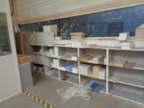a room that has shelves and boxes in it