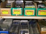 many boxes of electronic equipment on a shelf in a room