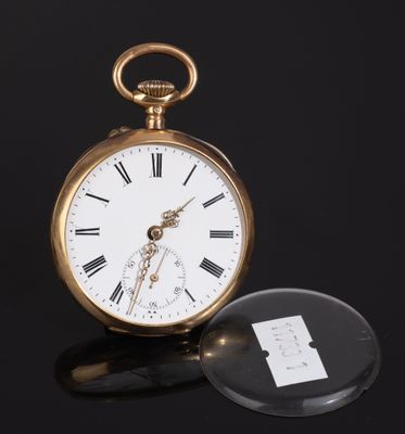 an antique pocket watch sitting on top of a black surface