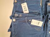 three pairs of blue jeans are stacked on top of each other