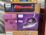 several boxes of different types of electric irons are stacked on top of each other