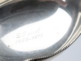 a close up of a silver spoon with a name engraved on it