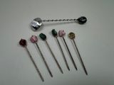 five different types of pins are arranged on a white surface