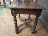 a small table with a wooden top on a wooden floor