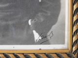 an old photo of a man in a suit and tie in a picture frame