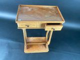 a small wooden table with a drawer on it