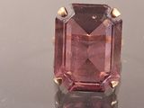 an image of a pink tourmaline gemstone ring on a reflective surface
