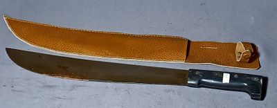 a knife and a leather sheath on a table