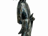 statue of a woman with a fan on her head holding a flower