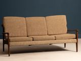 an image of a couch in a room with a blue wall