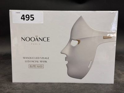 a box with a white mask on it on a table