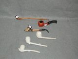 a pipe, a pipe holder, a pipe holder, and a pipe holder on a table
