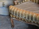 a chair and a chest of drawers in a room