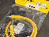 a close up of a yellow hose on a black surface