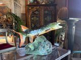 a statue of a fish on a table in a living room