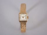 an image of a women ' s wrist watch with a gold band