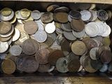 a box full of coins sitting on a table