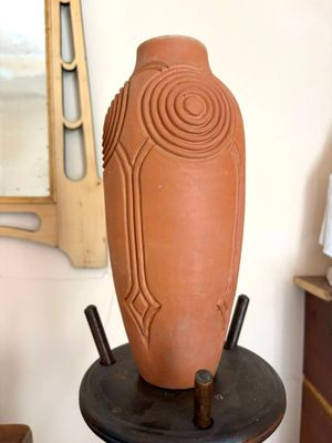 un vase posé sur un socle dans une pièce