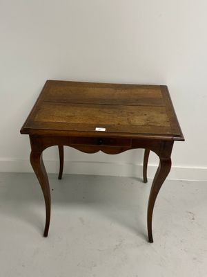 a small wooden table with a small drawer on it