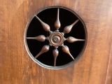 a wooden cabinet with a fan in the middle of it