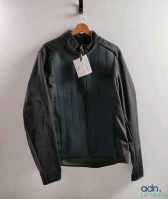 black leather jacket hanging on a hanger with a tag on it