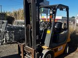 a forklift truck that is parked in the dirt