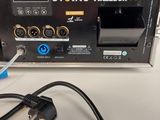 a close up of an electronic device on a table with a charger