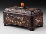 a wooden box with an orange on top of it