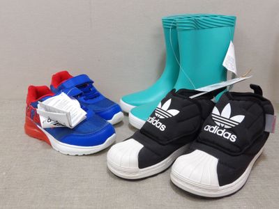 three pairs of adidas shoes and a pair of rain boots