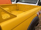 a yellow truck that is parked next to other trucks