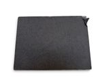 a close up of a piece of black paper on a white surface