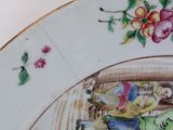 a plate with flowers and birds painted on it
